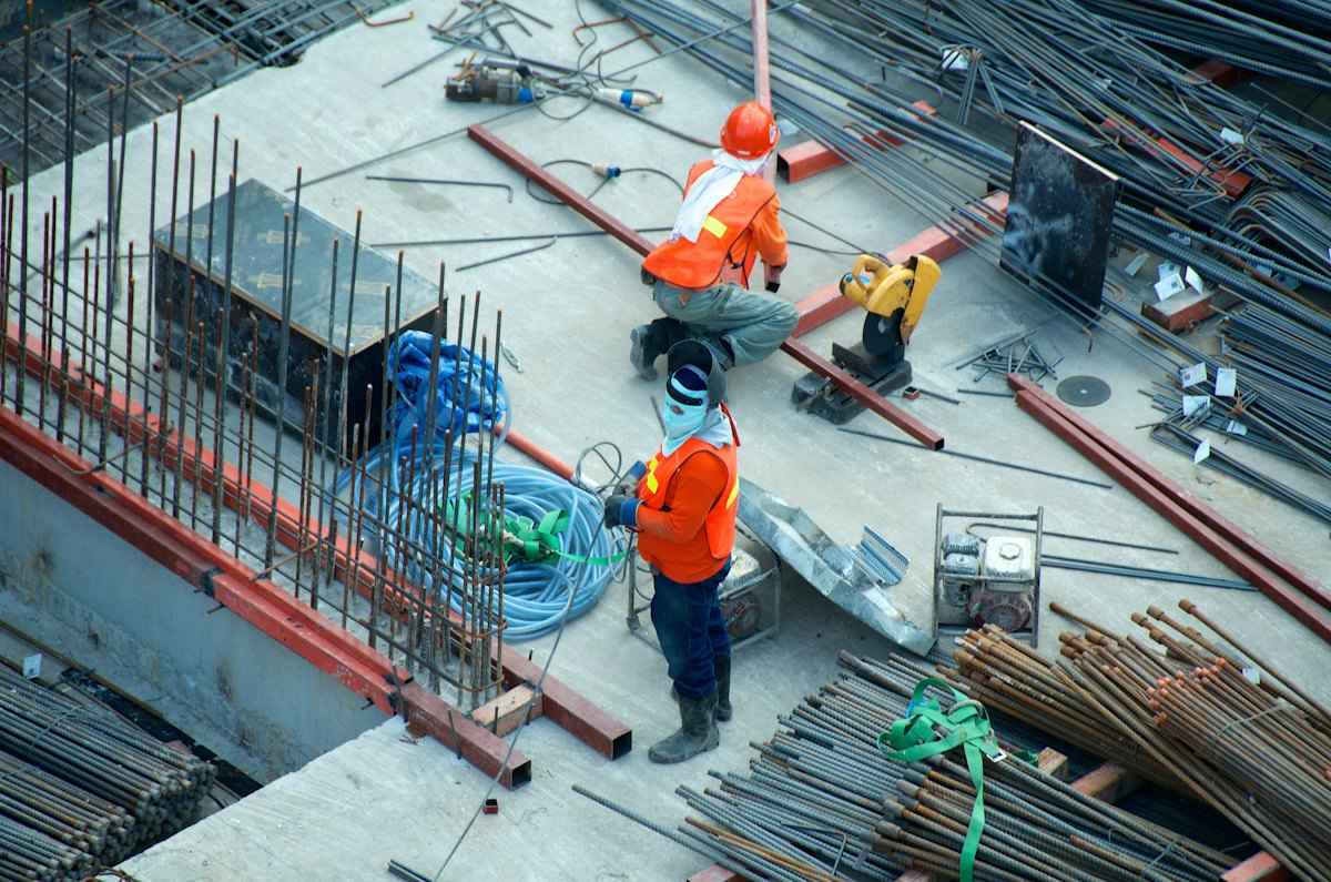 Construction site with cranes and earthmoving equipment at work.