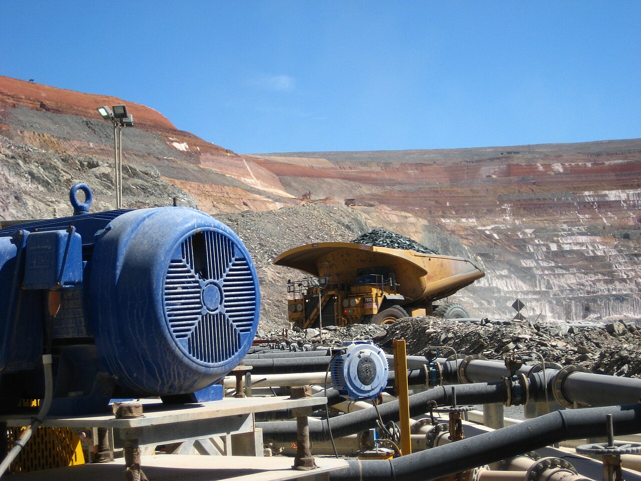 Heavy excavation machinery working at an opencast mining operation.