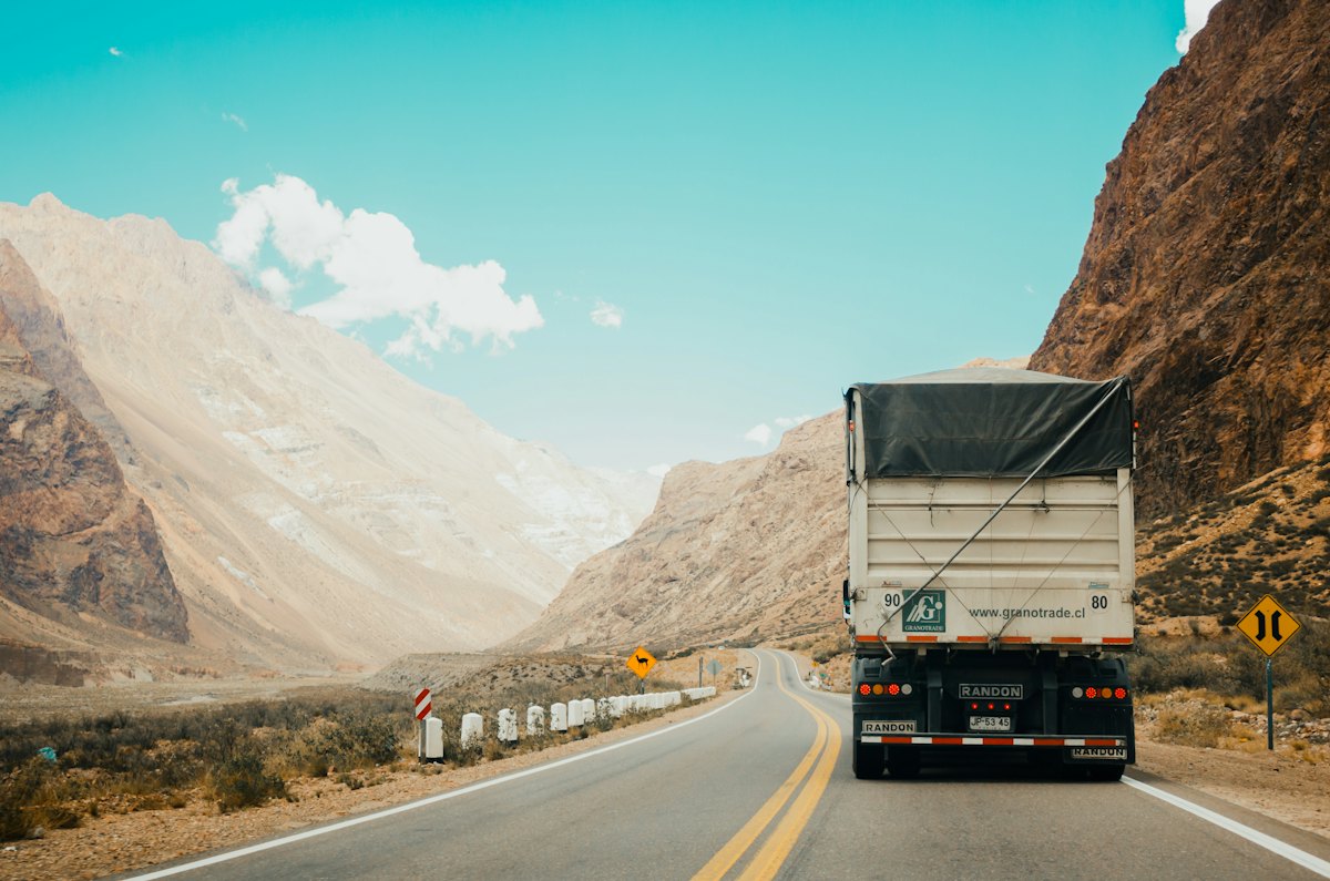 A line of heavy-duty freight trucks at a logistics depot.